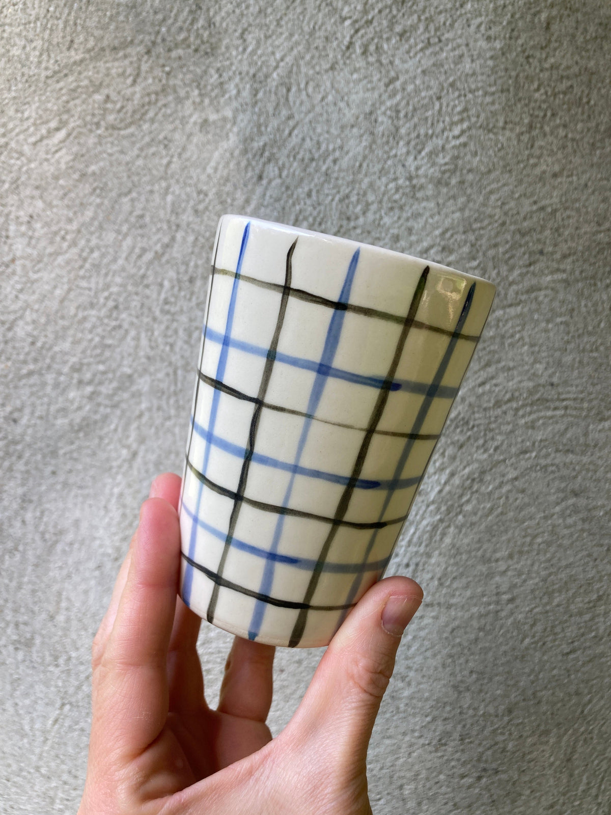 Ceramic cup with blue and black grid
