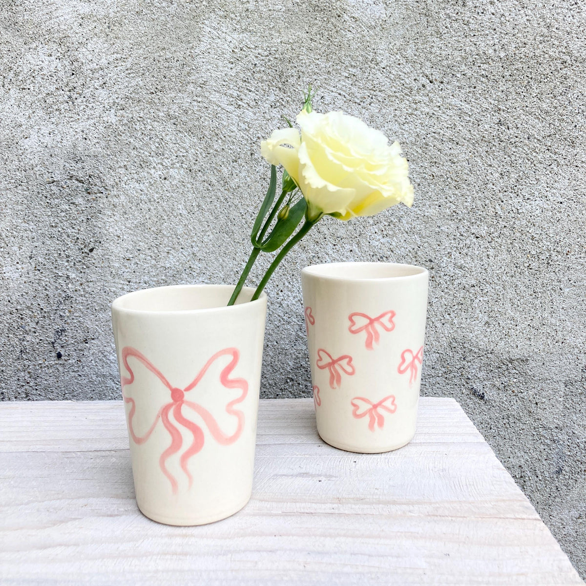 Ceramic cup with pink bows all over
