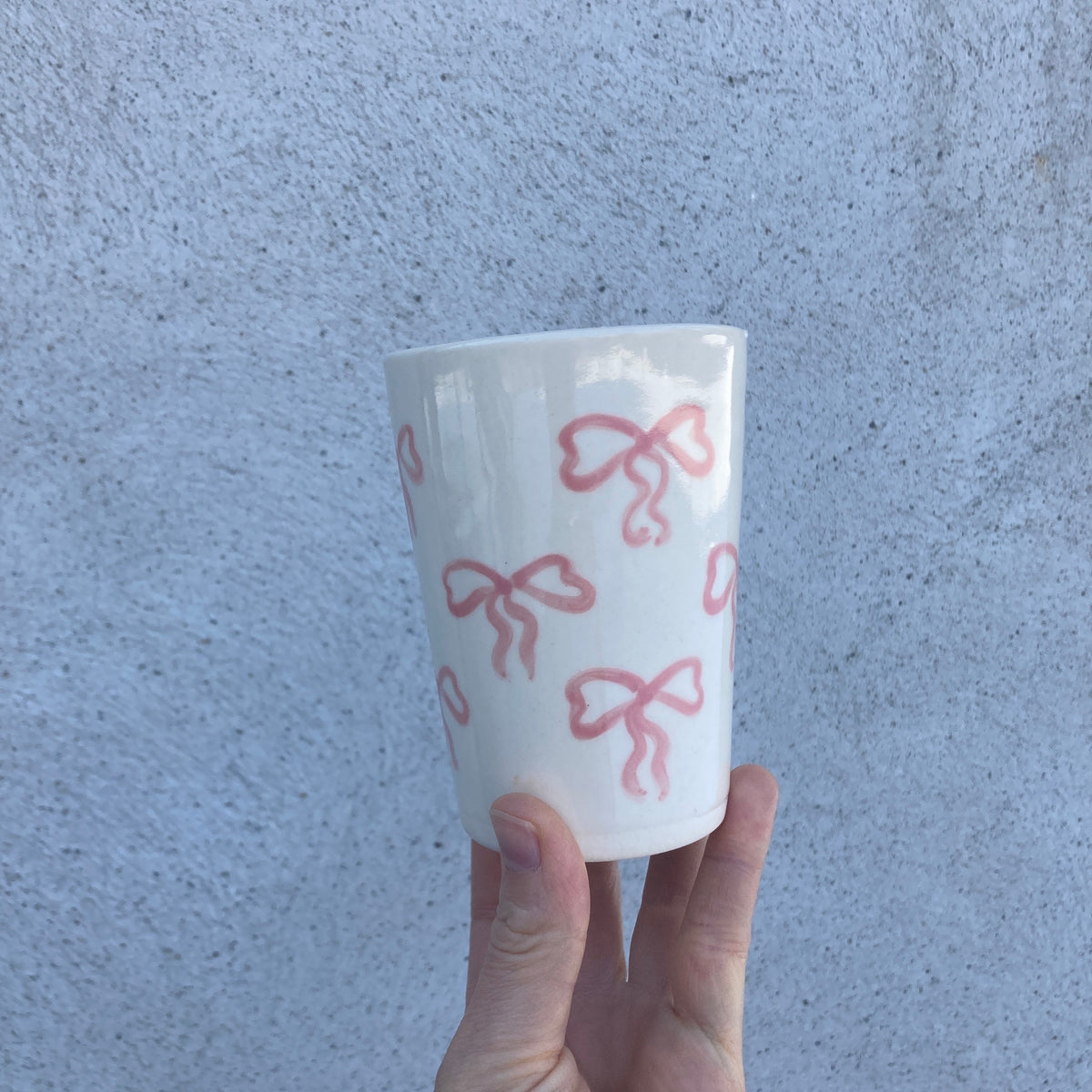 Ceramic cup with pink bows all over