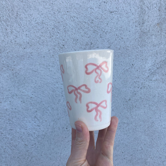 Ceramic cup with pink bows all over
