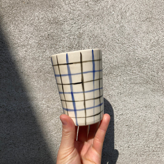 Ceramic cup with blue and black grid