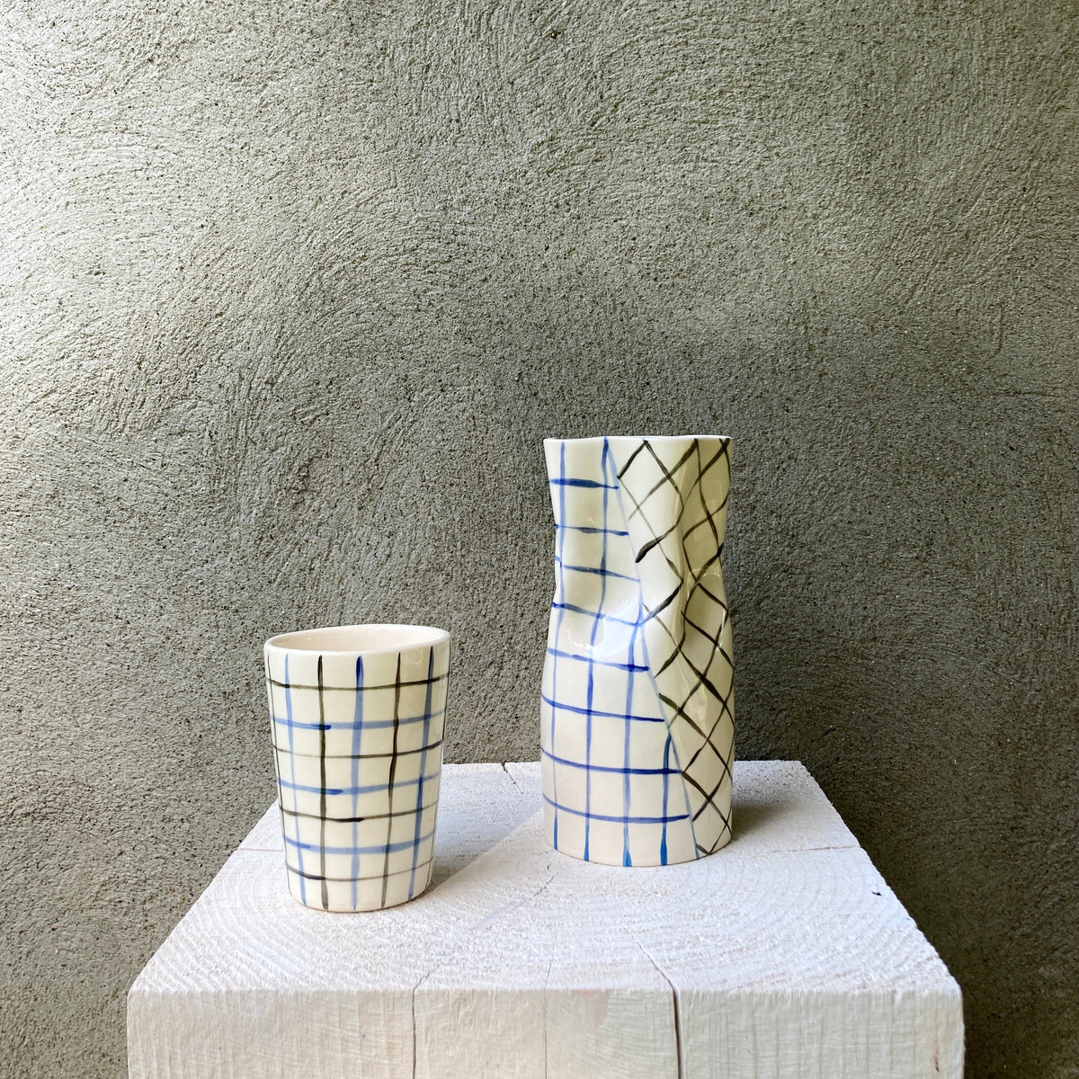 Ceramic cup with blue and black grid