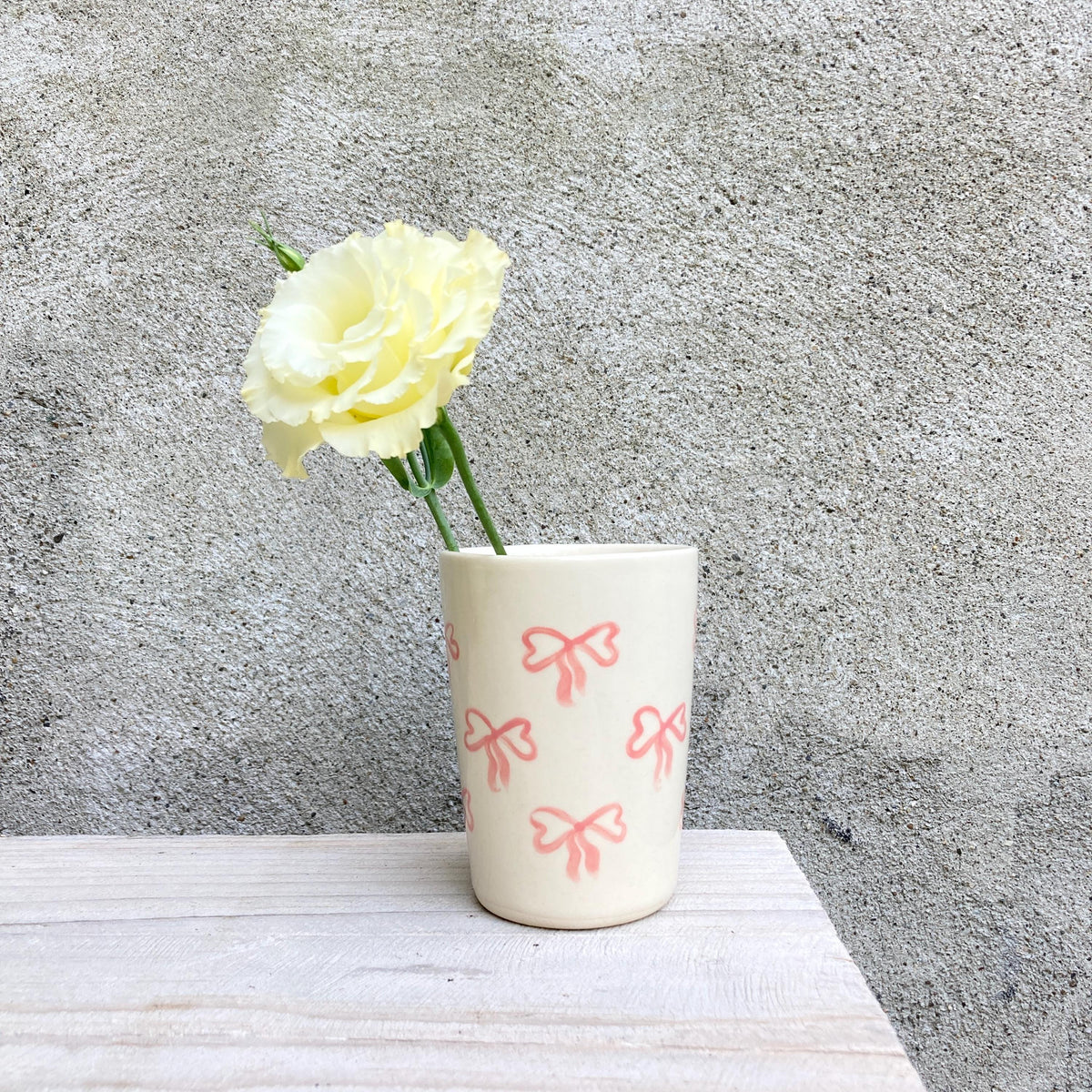 Ceramic cup with pink bows all over