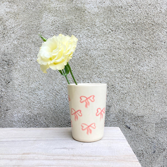 Ceramic cup with pink bows all over